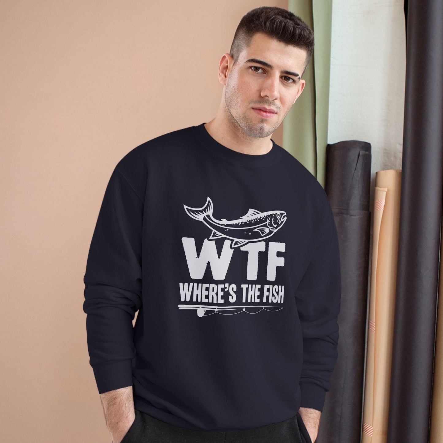Man wearing a black sweatshirt with 'WTF Where's the Fish' text and graphic.
