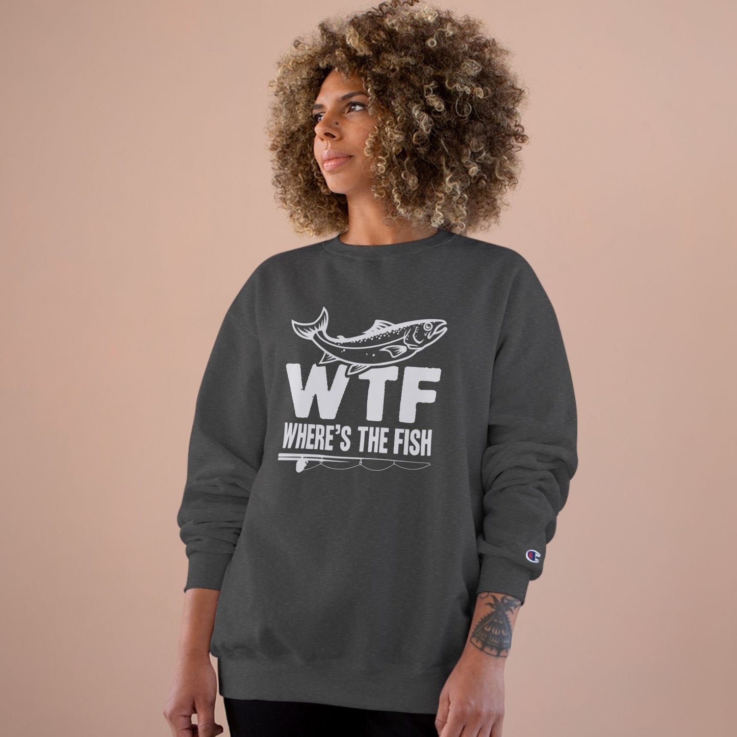 A dark gray sweatshirt with 'WTF' Where's the Fish' graphic on a beige background