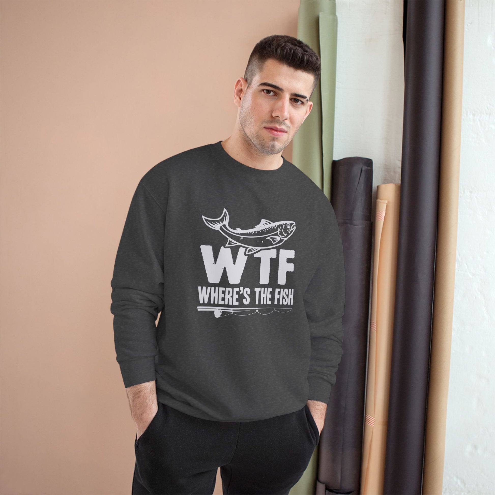 Man wearing a dark gray sweatshirt with 'WTF Where's the Fish' text and graphic.